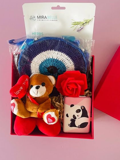 A budget-friendly Valentine's gift box. This one includes a teddy bear, a power bank, a face mask, and an evil eye dreamcatcher.
