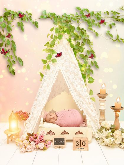 A beautiful, personalized setup featuring a baby in a lace tent with her name and birth date displayed on wooden blocks. I love adding these custom touches to your session.