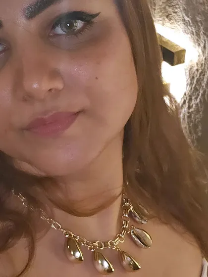 A close-up of my look for 'The White Party'. The gold shell and cowrie necklace adds a touch of beachy, bohemian elegance to my all-white outfit.