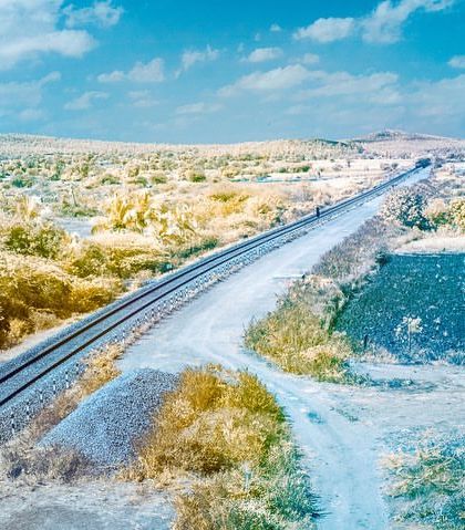 A railway line cutting through the landscape, captured in false-colour infrared. The world takes on a completely different palette.