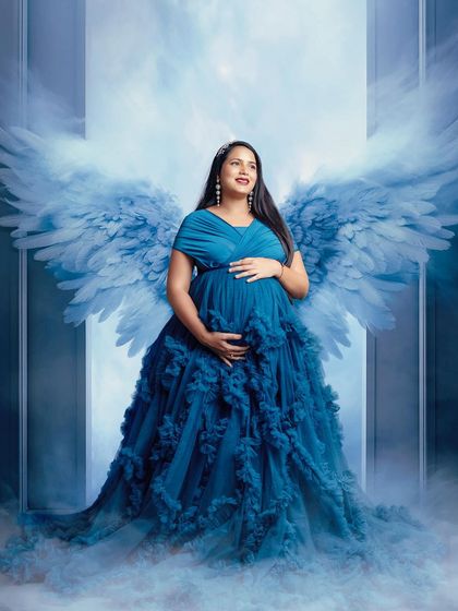 A true goddess moment. This royal blue ruffled gown paired with digitally added angel wings creates a powerful and majestic maternity portrait.