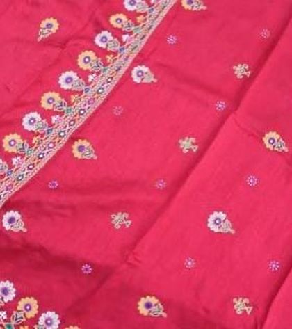 A vibrant pink hand-embroidered textile, showcasing the rich colours and detailed craftsmanship of our artisan partners.