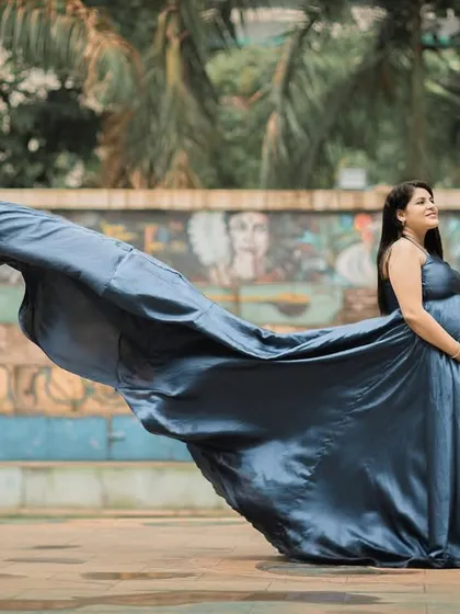 Another dynamic "flying dress" shot, capturing the motion of the fabric against an interesting outdoor wall.
