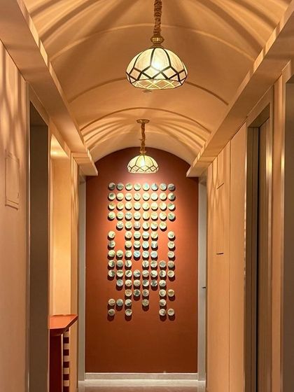 The full view of the "100 Little Landscapes" installation. It makes a huge impact and tells a story of nature and travel down the length of the hallway.