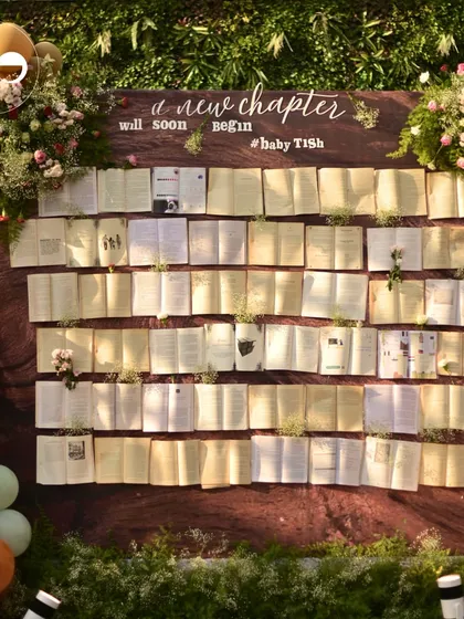 For a book-themed baby shower, I designed this unique 'New Chapter' wall featuring open books and delicate flowers. It’s an example of how I love to build creative, interactive photo backdrops that perfectly match your story.