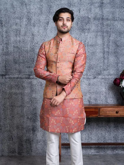 The Versaverve bundi set, featuring a rich, patterned fabric in shades of peach and pink. This outfit is designed to command attention with its unique visual appeal.