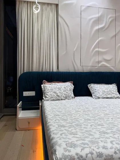 Another angle of the master bedroom, showing the interplay of the ambient under-bed lighting, the dramatic 3D wall, and the soft curtains.