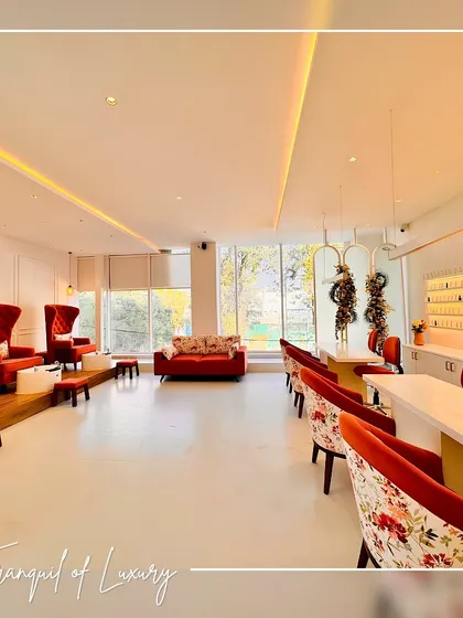 For the Fingertips Nail Studio, the goal was to create a space that feels both luxurious and tranquil. This wide view shows the pedicure and manicure stations, where I used a combination of plush, high-back red chairs and floral-patterned seating to add a pop of color and playful sophistication against a clean, white backdrop. The layout is open and airy, maximizing natural light to create a welcoming environment for clients.