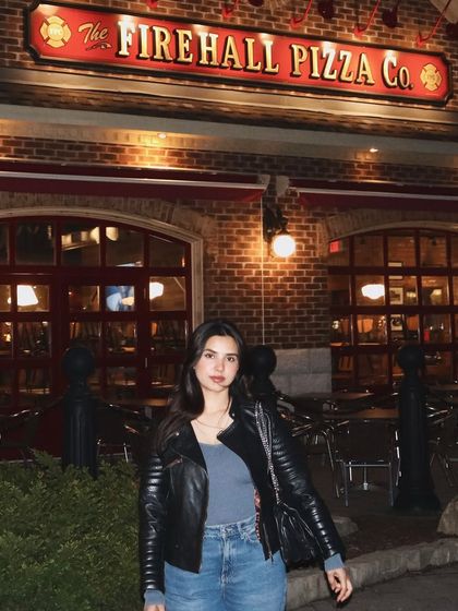 A night shot outside a pizza place in Blue Mountain. This captures a cozy, evening vibe, perfect for showing a complete day-to-night experience.