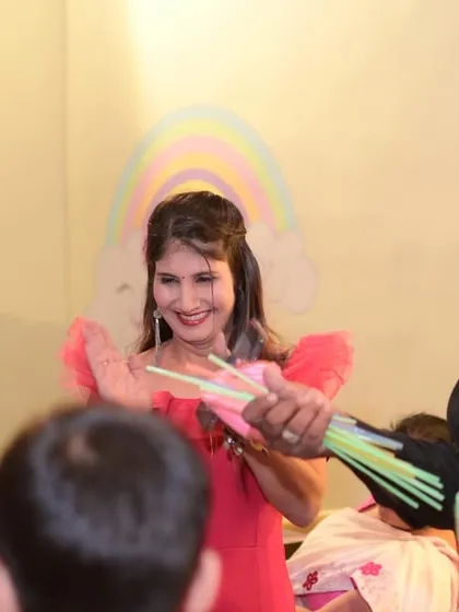 A magician handing out bubble wands during a performance. Interactive entertainment is key to keeping young guests captivated.