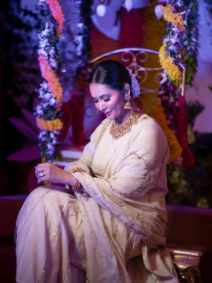 A candid, downward glance of Kavya Gowda, capturing a quiet, graceful moment amidst the celebration.