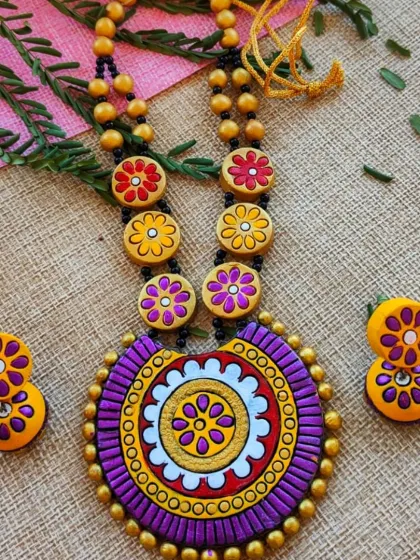 A regal purple and yellow version of the mandala and floral bead necklace.