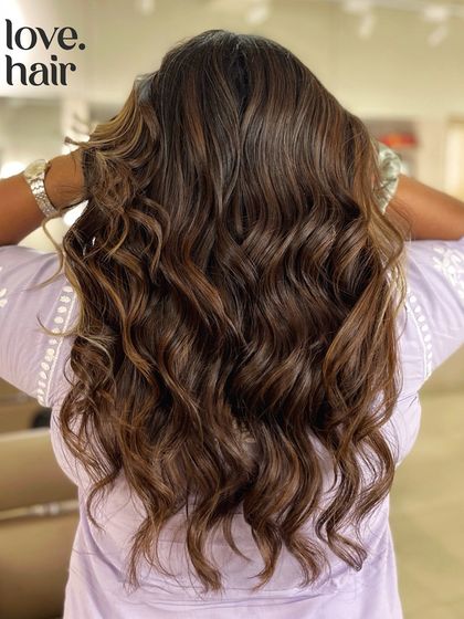 The back view of our 'chocolate chips and crème brûlée' balayage, showing the beautiful interplay of light and dark tones.
