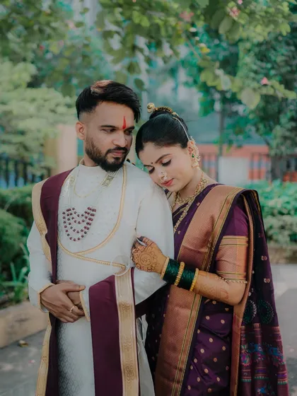 A tender moment where the bride rests her head on the groom's shoulder. His protective arm around her and their serene expressions convey a sense of peace and deep affection.