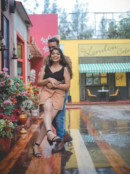 A romantic and playful pose in a charming "London Cafe" themed setting, perfect for a creative pre-wedding shoot.
