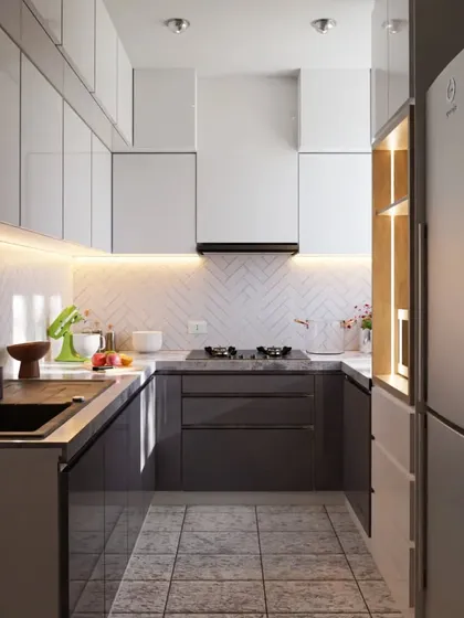 A compact and highly efficient U-shaped modular kitchen. The design uses a two-tone scheme with white upper cabinets to keep the space feeling open, while herringbone tiles and under-cabinet lighting add a touch of style.