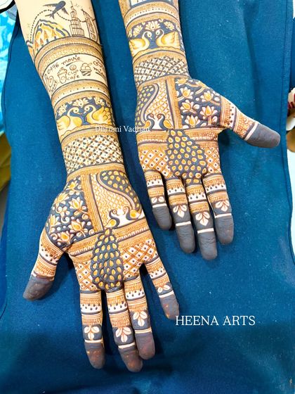 A customized engagement mehendi with a mix of peacocks, lotuses, and personalized elements.