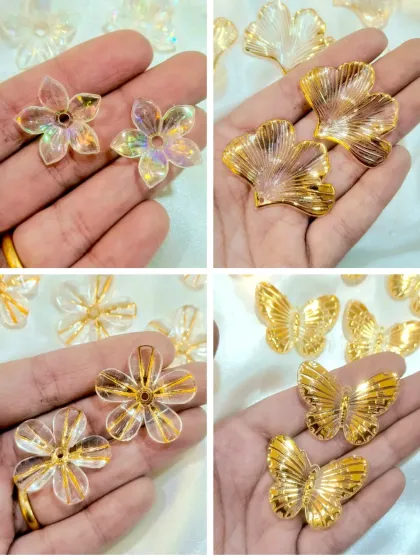 These decorative acrylic add-ons, including iridescent flowers and golden butterflies, are perfect for embellishing resin art. They catch the light beautifully when embedded in resin.