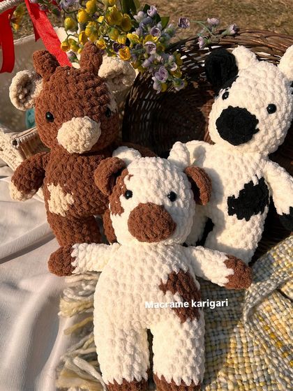 Three of our chunky yarn cows, each with a unique pattern. We offer both brown and black-and-white versions of these adorable farm animals.
