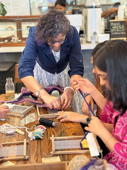 I keep my workshops small so I can offer personal, hands-on guidance to everyone. Here, I'm helping a student set up her loom and get started with her first stitches. It's a relaxed, supportive space where you can ask questions and learn at your own pace.