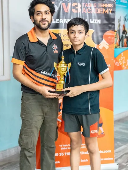 Presenting the winner's trophy to our U-15 Boys champion. These tournaments provide a crucial competitive outlet for teenage players to advance their game.