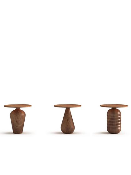 A trio of side tables from the 'Bernard and friends' line. The varied silhouettes of the turned wood bases showcase the versatility and artistic potential of handcrafted woodworking.