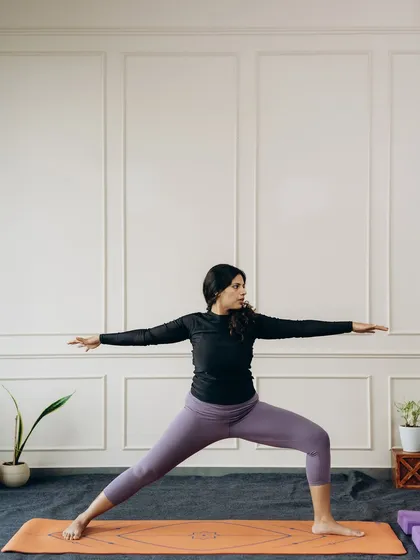 The foundational Virabhadrasana II (Warrior II), a powerful standing pose that builds strength in the legs and opens the hips.