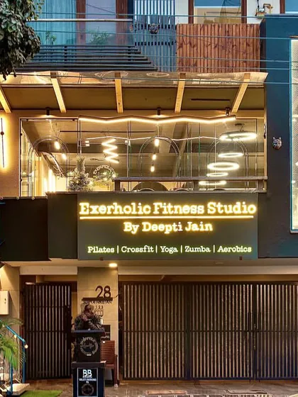 An evening view of the studio facade. The warm lighting creates a welcoming glow, inviting you into a space dedicated to your health and well-being.
