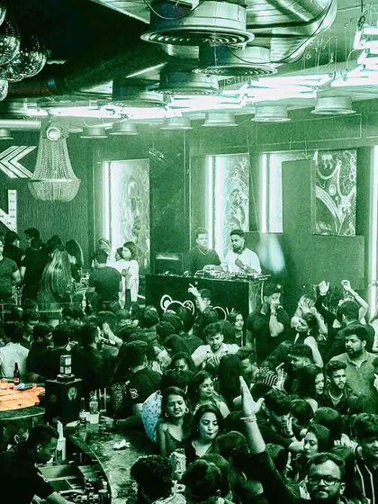 A green-tinted shot showing the entire bar area alive with energy. It's my goal to make sure every person in the venue is part of the experience.