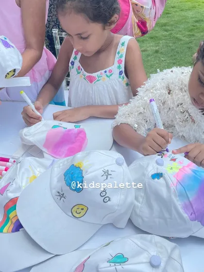 A table full of budding designers, each creating a one-of-a-kind cap. I provide a wide array of markers and decorations so their imaginations can run wild.