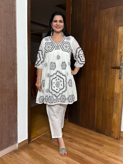 Statement earrings are another accessory I love. These large silver earrings add a touch of boho chic to this simple white embroidered kurti.