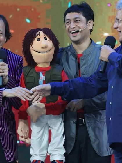 A heartwarming moment on stage with my father, Ramdas Padhye, and host Ashok Saraf during the celebration of our family's century-long journey in puppetry.
