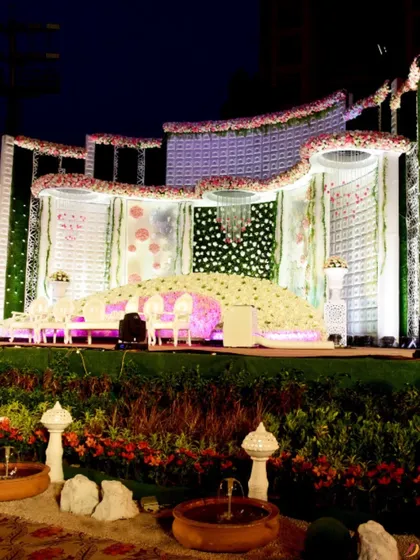 Another angle of the majestic floral stage, highlighting the intricate details and the sheer volume of flowers used. The small fountains in the foreground add a soothing sensory element to the grand design.
