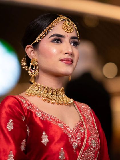 A side profile of a royal bridal look in a red lehenga, created for a Nykaa masterclass. The makeup is elegant and timeless.