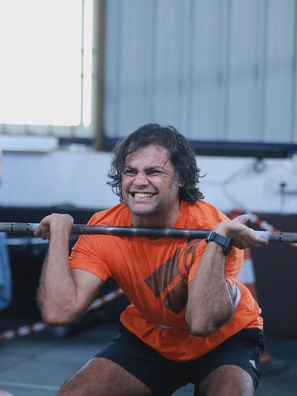 The "pain cave" face. This athlete is digging deep during a heavy front squat, showing the mental and physical toughness required to compete.