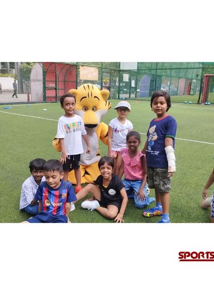 A happy group photo with our friendly tiger mascot. These are the moments that make a sports-themed birthday party so special for the kids.