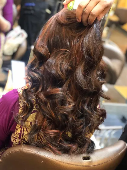 A side view of the caramel and brown highlights, showing how the color is distributed throughout the hair. This technique adds a lot of visual interest and texture.