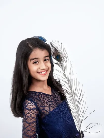 A simple and elegant studio portrait for kids. This shot focuses on her bright smile, using a clean white background to make her personality shine.