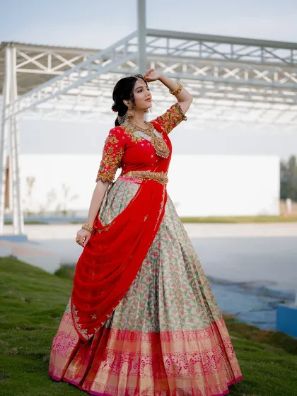 Capturing a wide shot of this traditional half saree shows how the entire outfit comes together. The pose and outdoor venue add a sense of grandeur to this celebrity photoshoot.