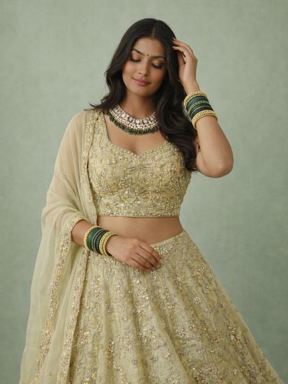 This candid-style shot captures the soft, romantic feel of the light green lehenga. The delicate net dupatta and sparkling details make it a truly dreamy outfit.