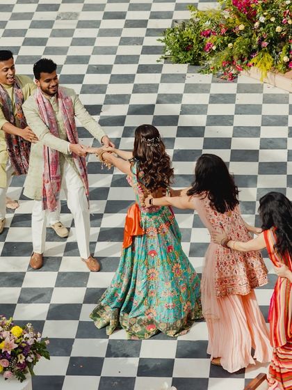 A fun tug-of-war between the bride's and groom's sides during a Mehendi performance. It's a great way to add some playful competition to the celebration.