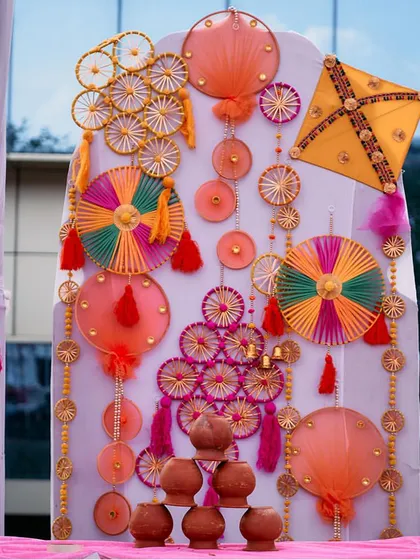 A creative photo booth backdrop made from colorful threads, kites, and clay pots. This is a great example of how I blend traditional crafts with modern design for a Mehendi.
