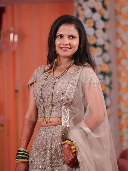 Asmita's full reception look, featuring a stunning silver lehenga. The soft, open hairstyle and radiant makeup allowed her to look effortlessly chic and comfortable throughout the celebration.
