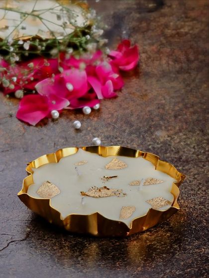My handmade mini gold metal urli soy candle, shown from the side. This piece is perfect for Diwali gifting or adding a warm, festive touch to smaller spaces and home celebrations.