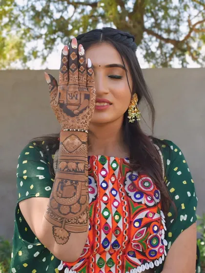 A closer look at one of my arms, featuring elephant motifs and a personalized design on the palm.