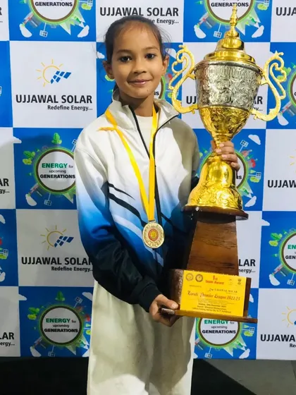 Bhavnika with her gold medal and the team trophy. Her dedication to karate is inspiring.