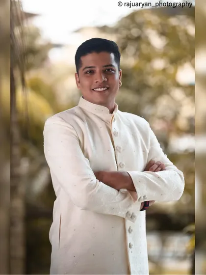 The groom's portraits are just as important. I focus on capturing his personality and style, like in this shot where his confident smile and classic sherwani create a sharp, timeless image.