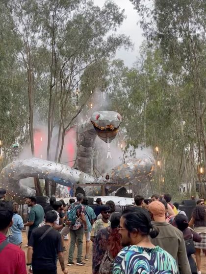 The giant snake stage at Echoes of Earth, this time during the day with smoke effects. It shows the impressive scale and artistry of the festivals I participate in.