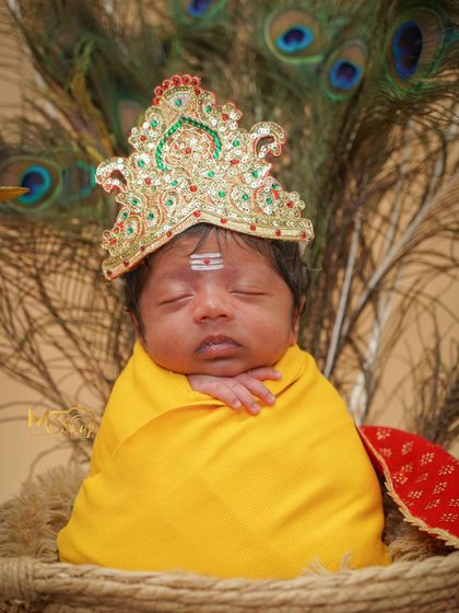A beautiful close-up of the baby in his divine costume. The lighting is soft and gentle, perfect for a newborn.