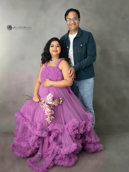 A vision in purple. This ruffled gown is a statement piece, and paired with a simple background, it creates a portrait that is both bold and beautiful.